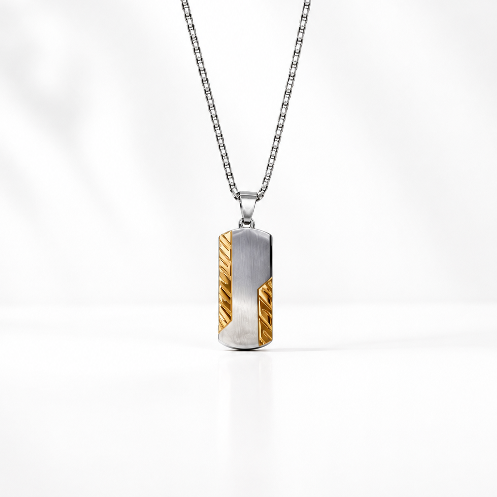 A silver-toned box chain for men necklace with a vertical rectangular pendant featuring a textured gold and silver design.