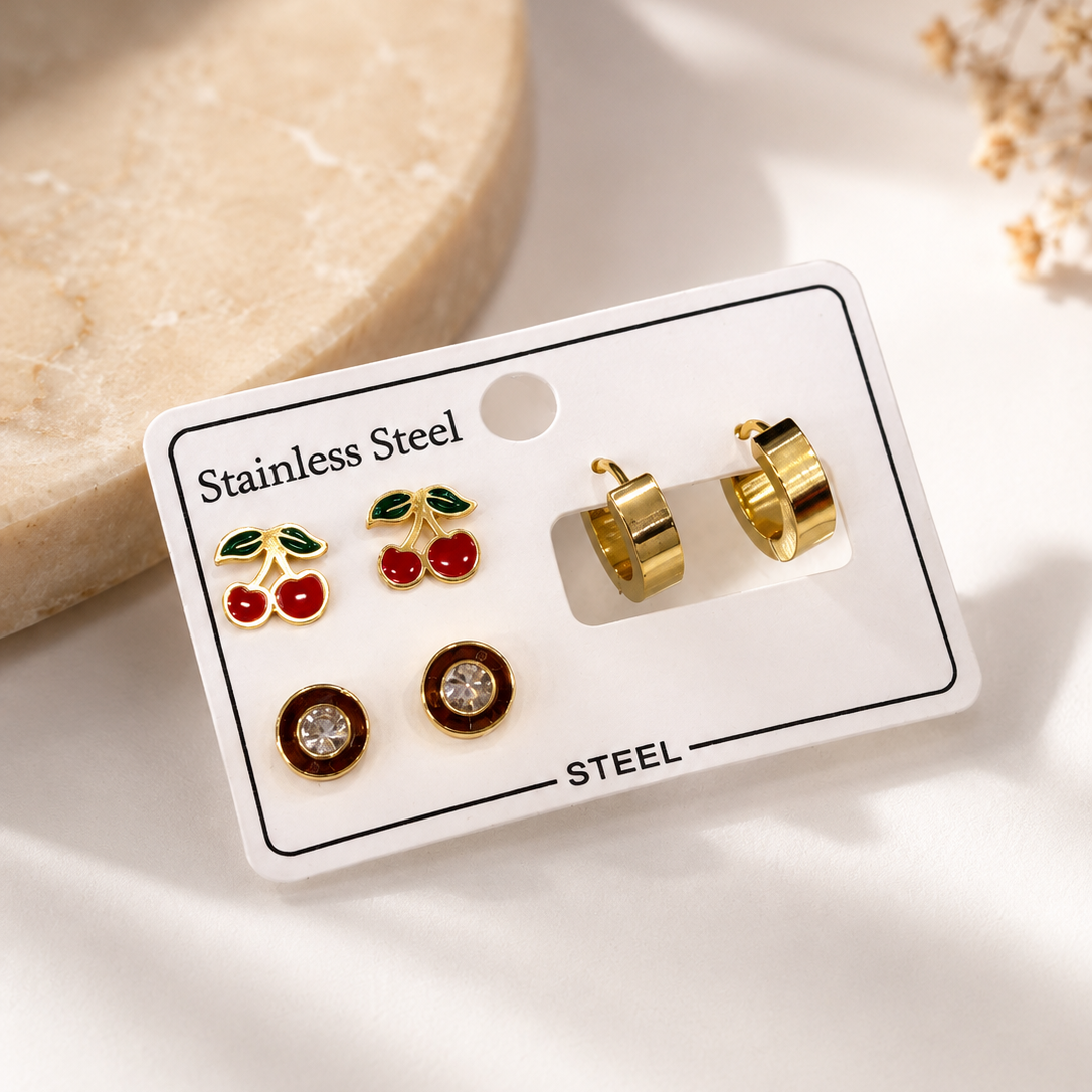 Shop a cute 3-pair gold earrings set for women in Qatar, featuring cherry, hoop and sparkling stud designs made with premium stainless steel