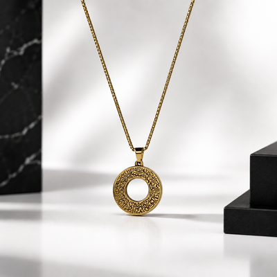 A gold ayat al kursi pendant for men necklace with an intricate circular filigree design, hanging from a gold chain