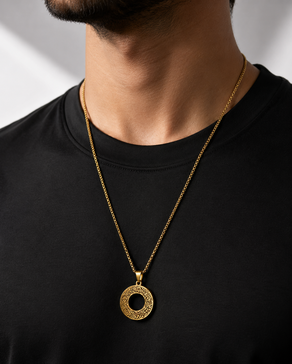 a gold chain for men necklace with a textured circular ayat al kursi pendant 
