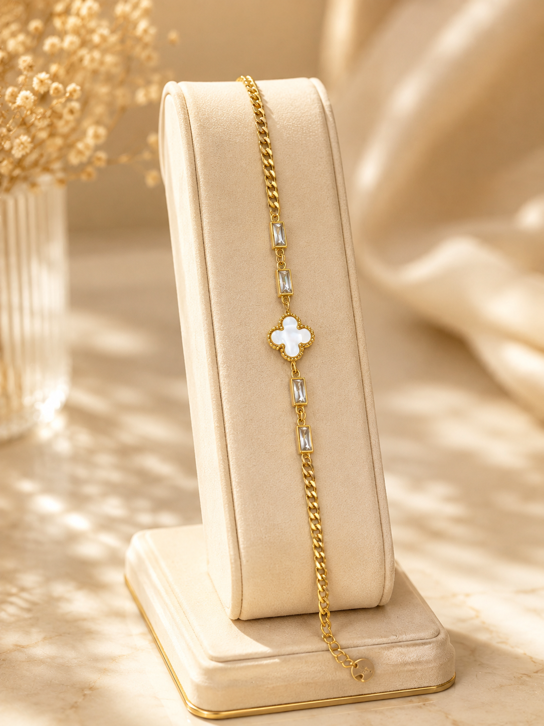Shop an elegant gold clover bracelet for women in Qatar, featuring a white floral charm and sparkling crystal accents. Perfect for everyday wear and gifting.