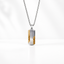 A silver-toned box chain for men necklace with a vertical rectangular pendant featuring a textured gold and silver design.