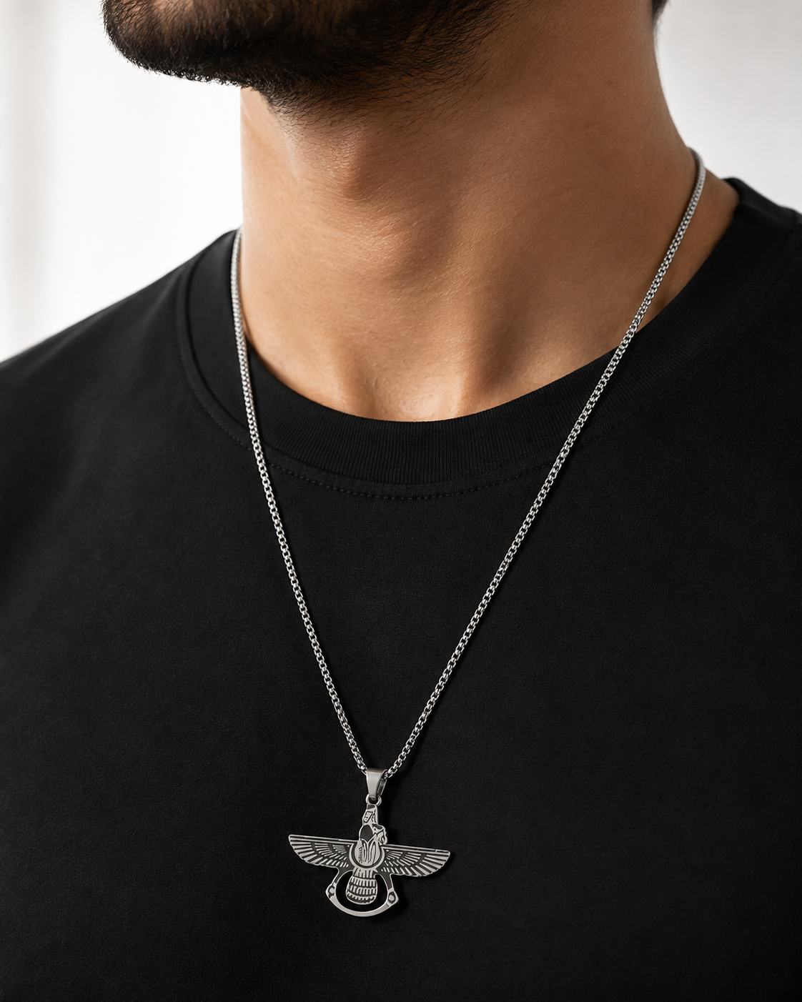 a man's neck and chest wearing a silver chain men necklace with a detailed winged  eagle pendant
