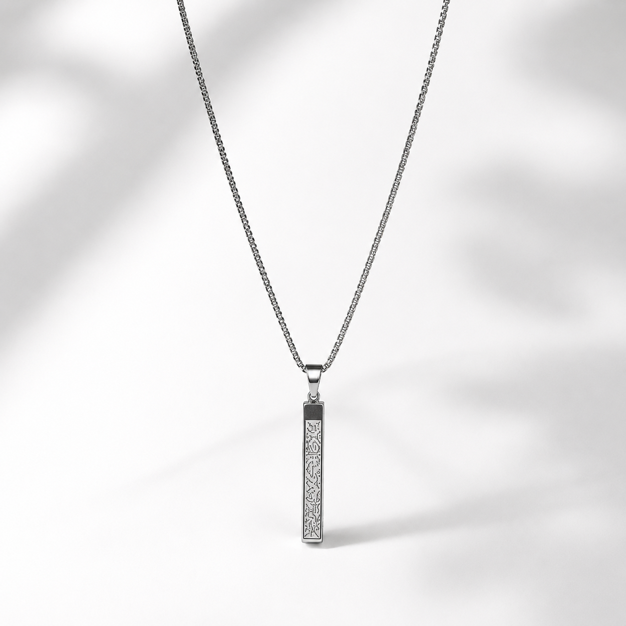 A silver-toned men necklace with a rectangular pendant featuring a textured ayat al kursi