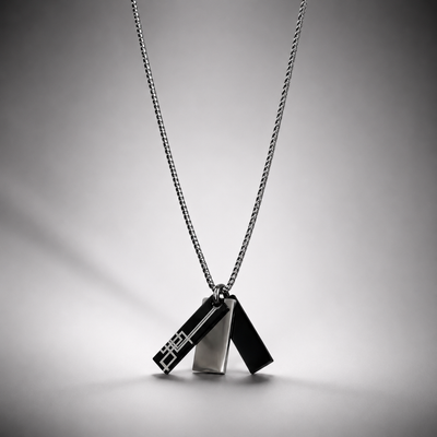 A silver-toned geometric 3 pendant for men necklace on a fine chain, featuring two interlocking triangular charms with a modern angular design in qatar